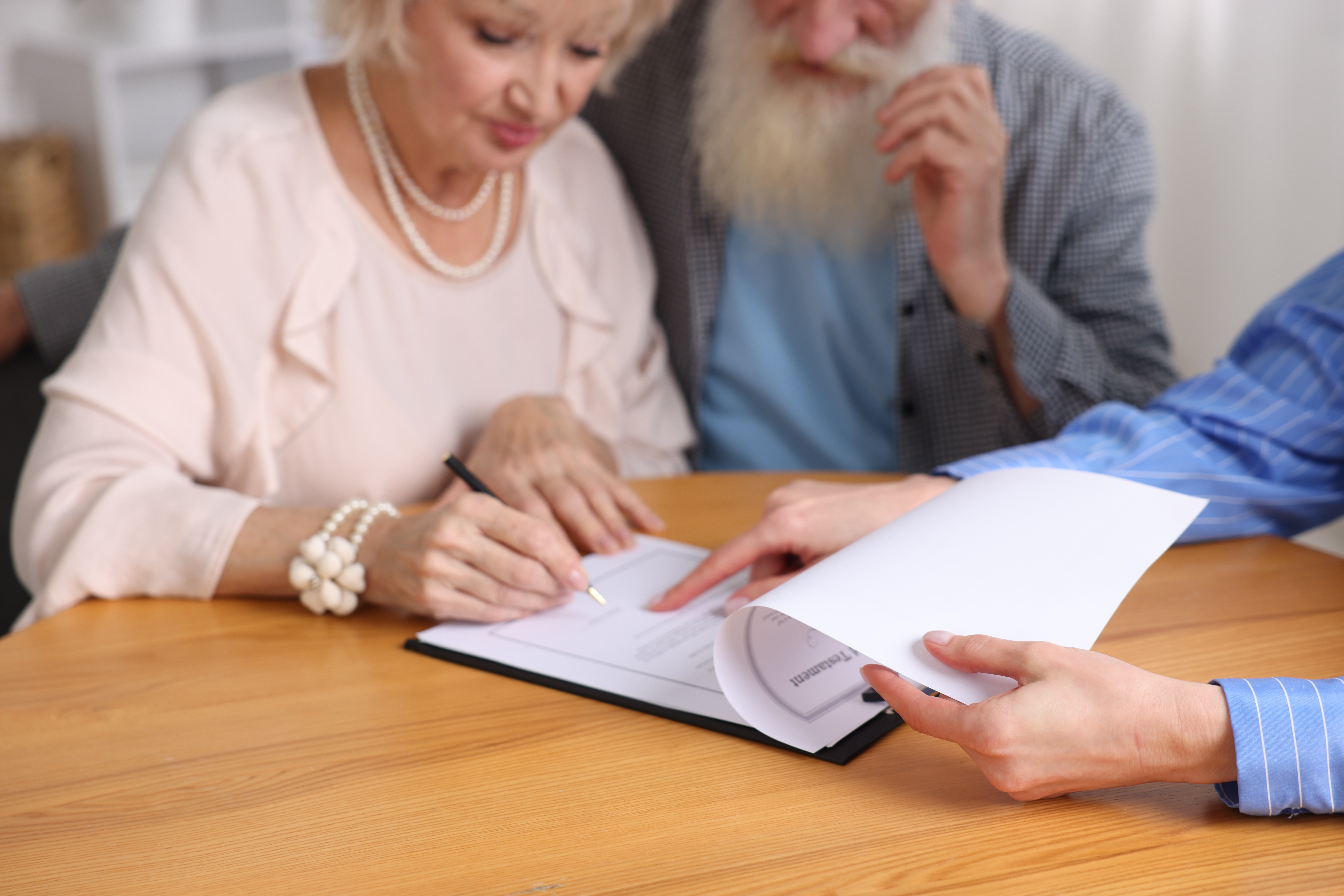 Senior couple reviewing legal documents with a legal professional